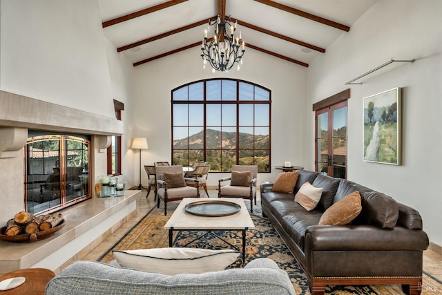 living area with high vaulted ceiling, a notable chandelier, and a healthy amount of sunlight
