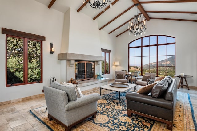 living room with baseboards, an inviting chandelier, beam ceiling, high vaulted ceiling, and a premium fireplace