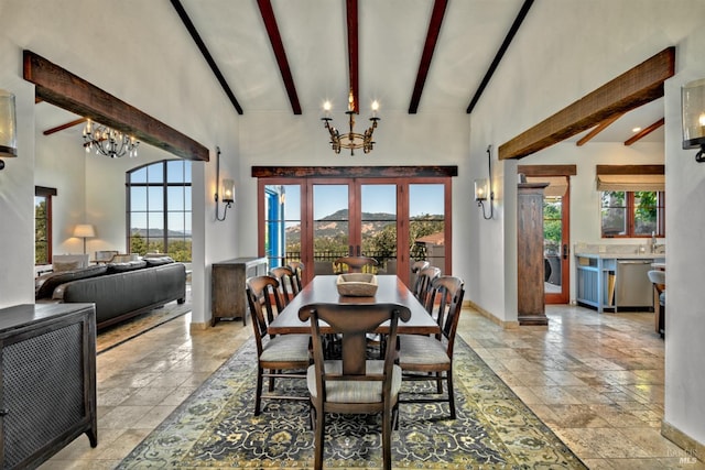 dining area featuring high vaulted ceiling, a wealth of natural light, and an inviting chandelier
