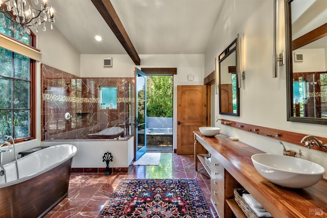bathroom featuring a freestanding tub, visible vents, marble finish floor, and a sink