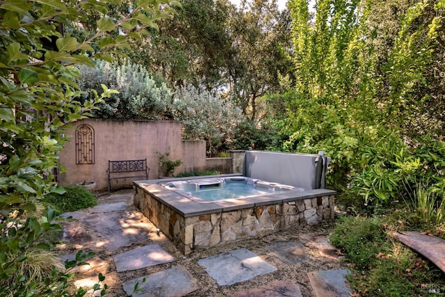 view of swimming pool with a covered hot tub