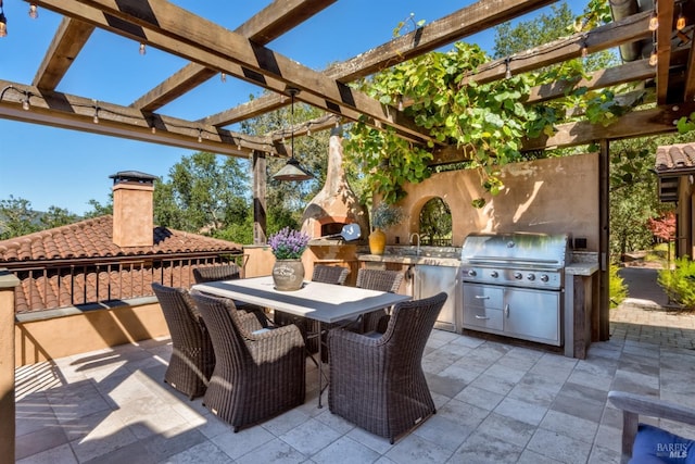 view of patio / terrace with grilling area, a pergola, outdoor dining area, and exterior kitchen