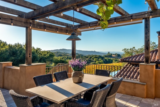view of patio / terrace with a mountain view, outdoor dining space, and a pergola
