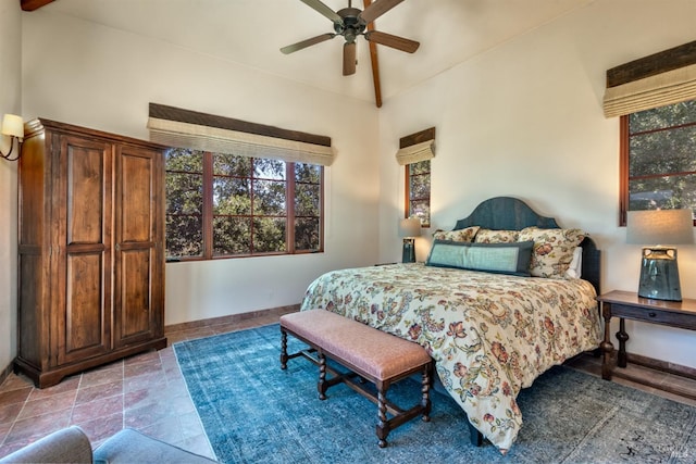 bedroom with ceiling fan and baseboards