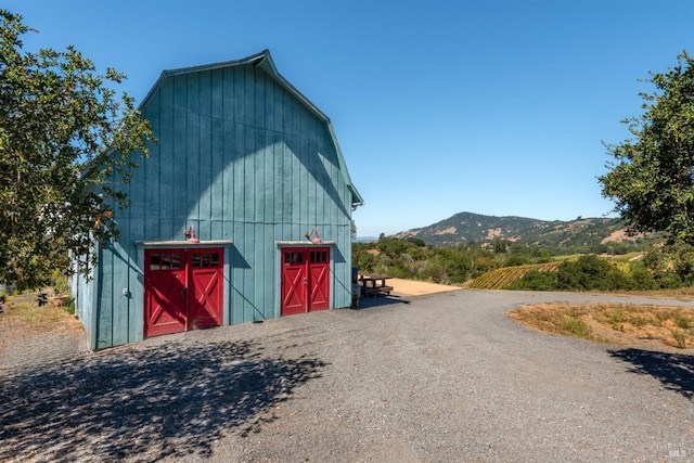 view of stable featuring a mountain view
