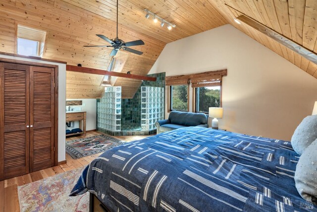 bedroom featuring high vaulted ceiling, track lighting, wooden ceiling, and wood finished floors