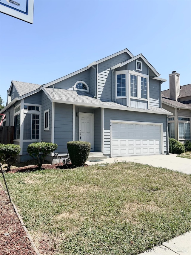261 Bridgewater Cir, Suisun City, CA 94585 - view of front facade with a garage, driveway, a front lawn, and board and batten siding