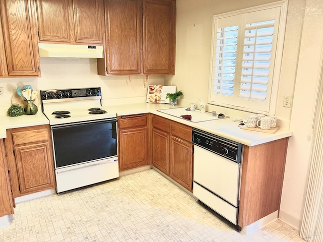 261 Bridgewater Cir, Suisun City, CA 94585 - kitchen with white appliances, under cabinet range hood, a sink, and light countertops