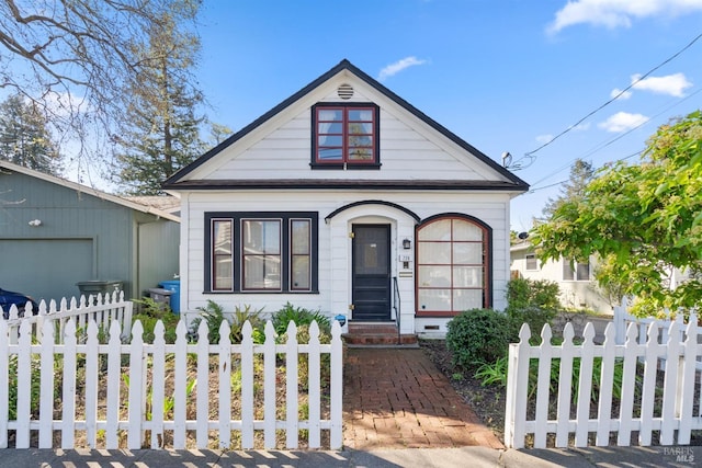 bungalow-style house with a fenced front yard