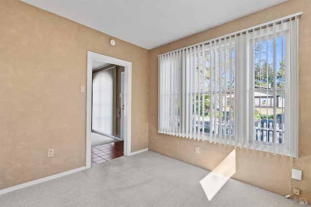 carpeted spare room with baseboards