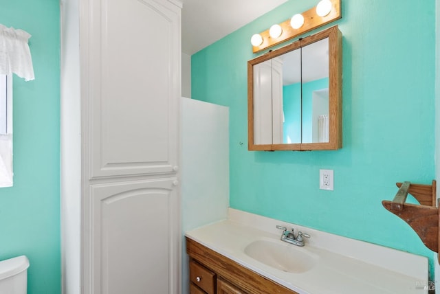 bathroom featuring toilet and vanity