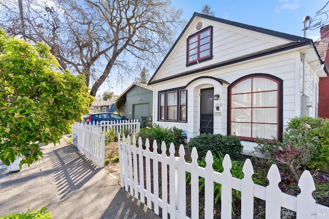 bungalow-style house with a fenced front yard