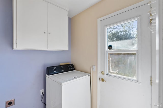 clothes washing area with cabinet space and washer / dryer