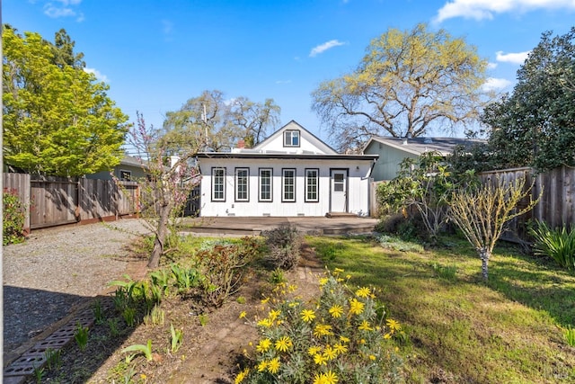 view of front of home featuring a fenced backyard and a deck