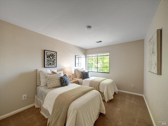 bedroom featuring visible vents, baseboards, and carpet flooring