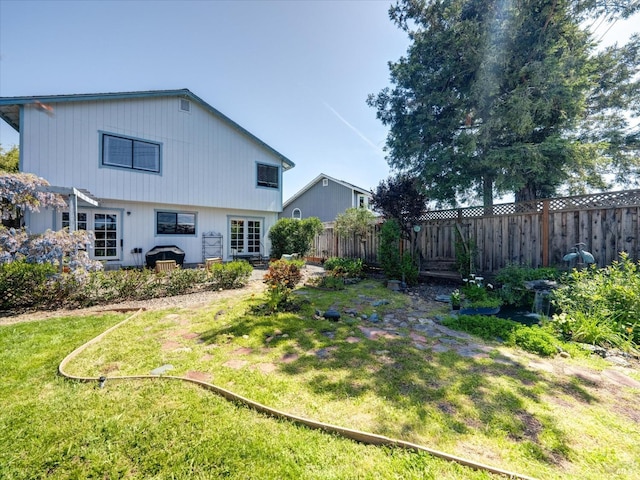 exterior space featuring fence and a lawn