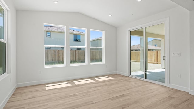 unfurnished room with recessed lighting, baseboards, vaulted ceiling, and light wood finished floors