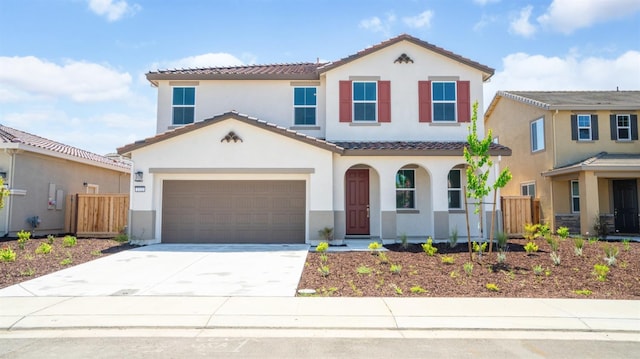 mediterranean / spanish-style home featuring fence, stucco siding, and a tile roof