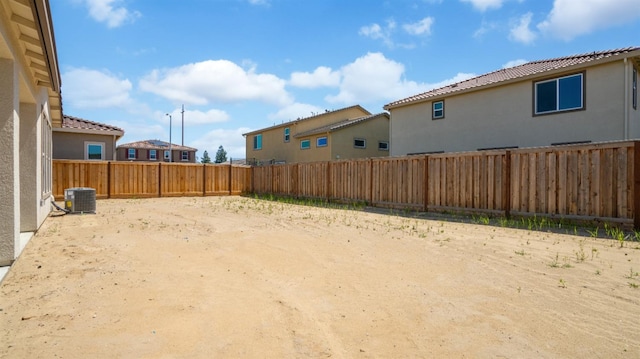 view of yard featuring cooling unit and a fenced backyard