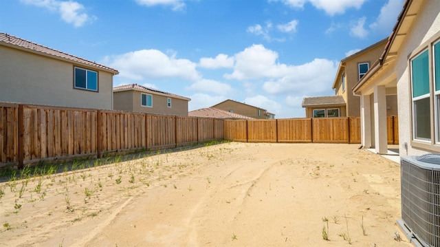 view of yard with central AC unit and a fenced backyard