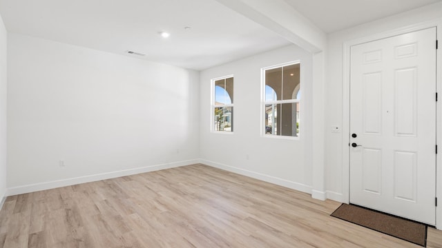 entrance foyer with baseboards, light wood-type flooring, and visible vents