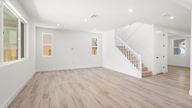 unfurnished living room featuring stairs, recessed lighting, visible vents, and light wood finished floors