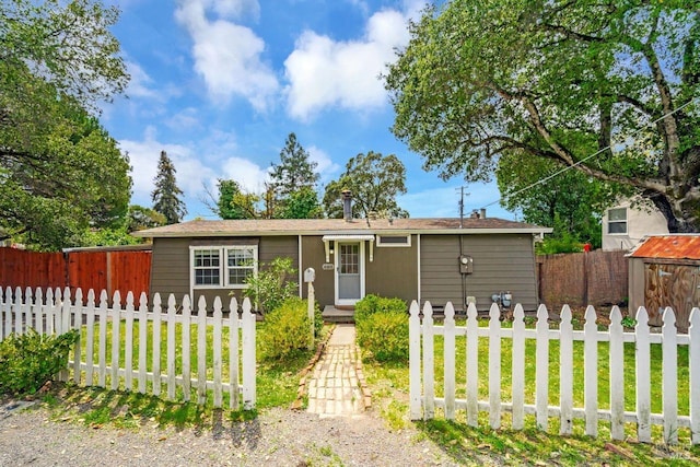 view of front of property with a front lawn and a fenced front yard