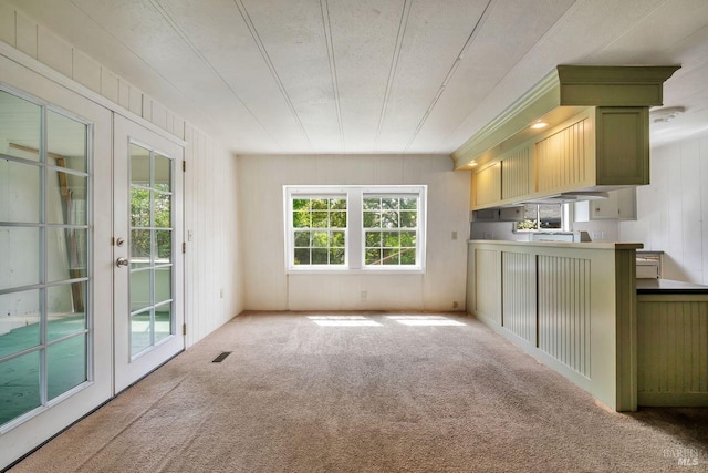 interior space featuring visible vents, carpet flooring, green cabinetry, and french doors