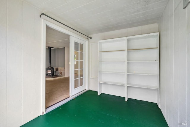 unfurnished sunroom with a wood stove