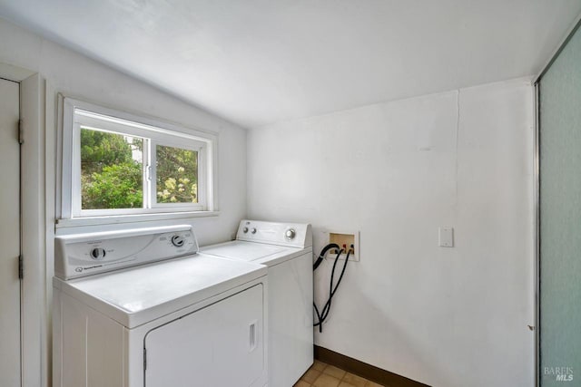 laundry area featuring baseboards, washer and dryer, and laundry area