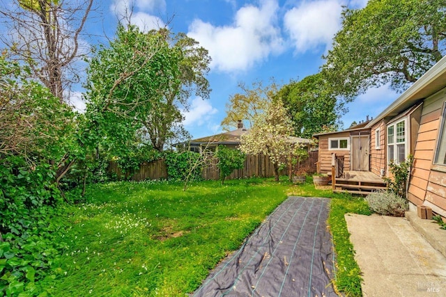 view of yard featuring a wooden deck and a fenced backyard