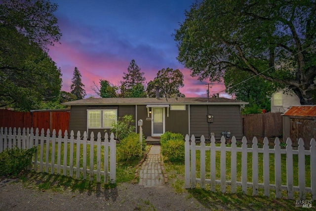 view of front of property with a front lawn and a fenced front yard