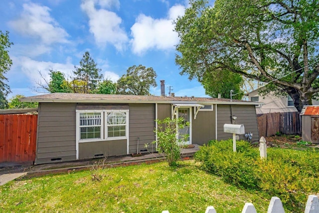 ranch-style home with crawl space, a front yard, and fence