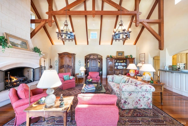 living room with arched walkways, a notable chandelier, beamed ceiling, and wood finished floors