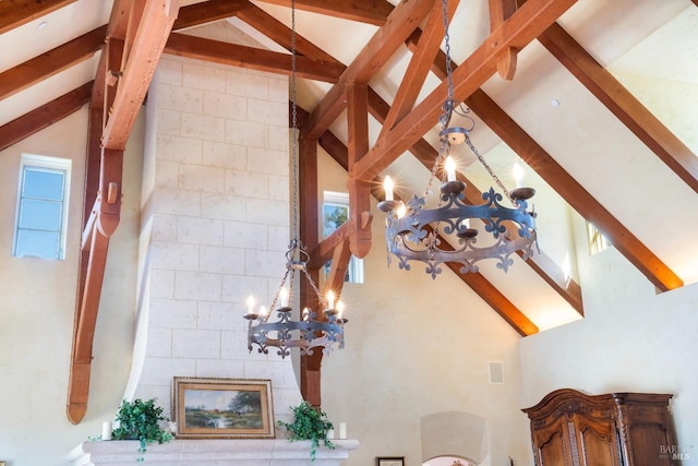 unfurnished living room featuring beam ceiling, high vaulted ceiling, and an inviting chandelier