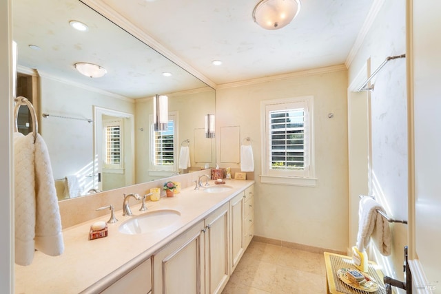 bathroom featuring a sink, ornamental molding, baseboards, and tile patterned flooring