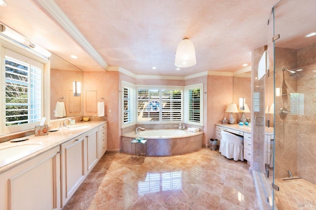 bathroom with a garden tub, a shower stall, ornamental molding, a sink, and double vanity