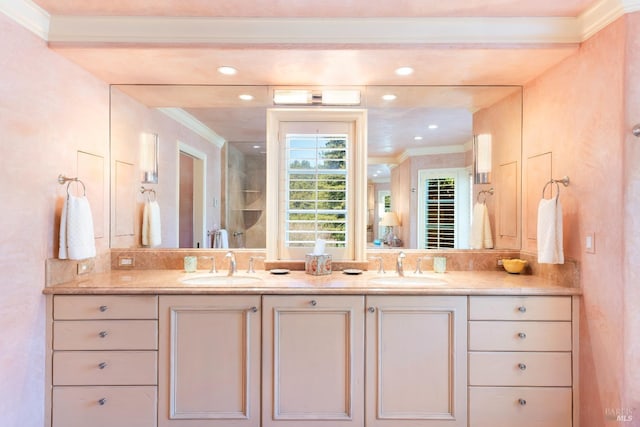 bathroom featuring double vanity, a sink, and ornamental molding
