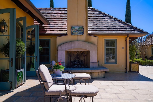 view of patio / terrace featuring exterior fireplace