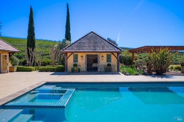view of swimming pool with a patio, an outdoor structure, a pergola, a pool with connected hot tub, and a storage structure