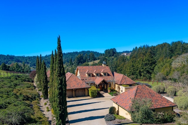 drone / aerial view featuring a wooded view