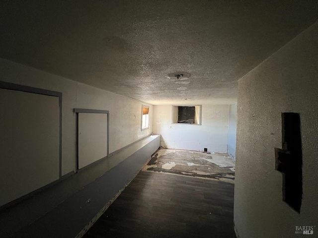 corridor featuring a textured ceiling