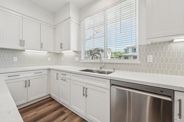 kitchen featuring a sink, dark wood finished floors, white cabinetry, stainless steel dishwasher, and decorative backsplash