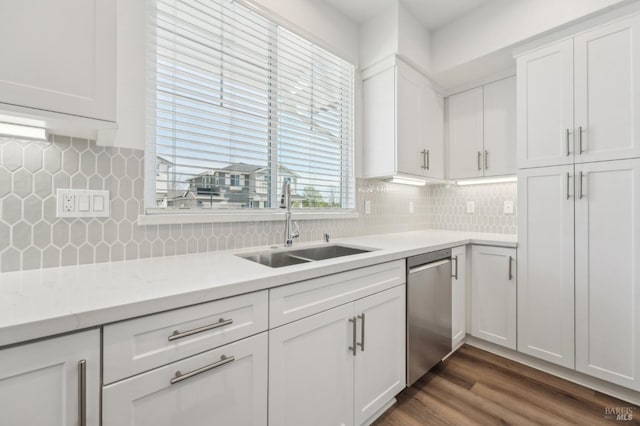 kitchen featuring light countertops, dishwasher, a sink, and dark wood-style floors
