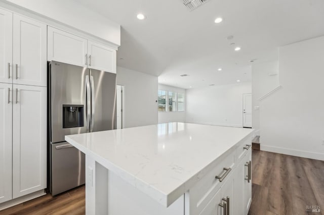 kitchen featuring stainless steel fridge with ice dispenser, white cabinets, recessed lighting, a center island, and dark wood-style floors