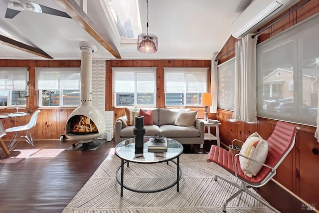 interior space with a wood stove and beam ceiling