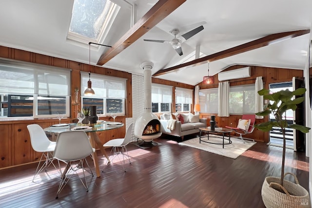 living area with a wall mounted air conditioner, wooden walls, ceiling fan, vaulted ceiling with beams, and wood finished floors
