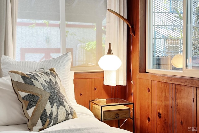 bedroom featuring wood walls
