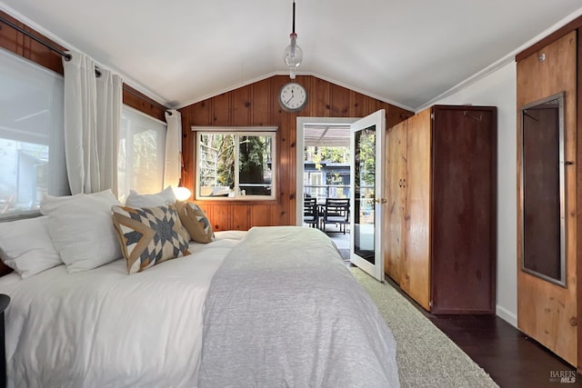 bedroom with wood walls, access to outside, and lofted ceiling