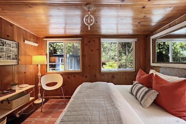 bedroom featuring wood walls, multiple windows, and wood ceiling